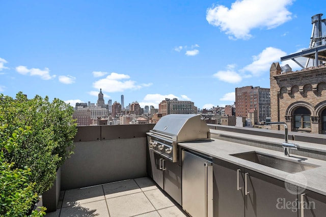 view of patio featuring a view of skyline, a grill, exterior kitchen, and a sink