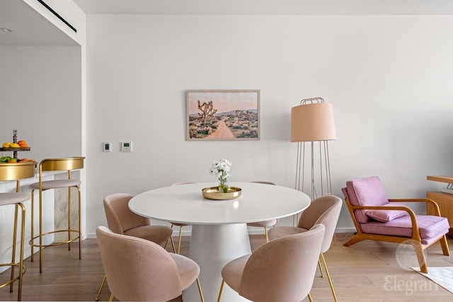 dining area featuring wood finished floors and baseboards