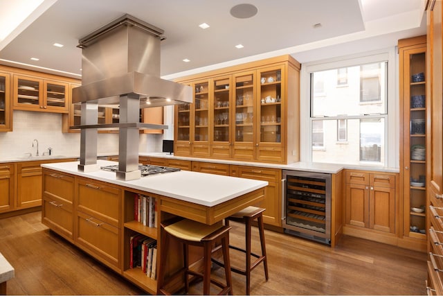 90 Riverside Dr Unit 14A, New York City, NY 10024 - kitchen featuring wine cooler, island exhaust hood, a center island, wood finished floors, and recessed lighting