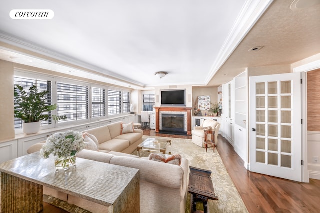 233 E 69th St Unit 14Klm, New York City, NY 10021 - living room featuring a fireplace with flush hearth, wood finished floors, and ornamental molding