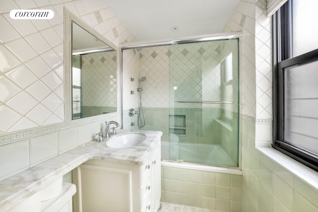 233 E 69th St Unit 14Klm, New York City, NY 10021 - bathroom with tile walls, tiled shower / bath, toilet, and vanity