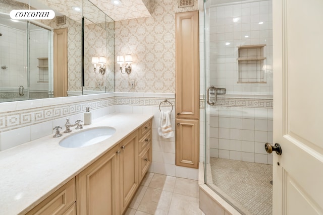 233 E 69th St Unit 14Klm, New York City, NY 10021 - full bath with a stall shower, tile patterned flooring, vanity, and tile walls