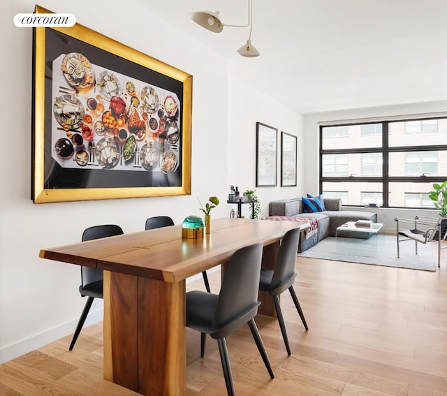 dining space with wood finished floors and baseboards