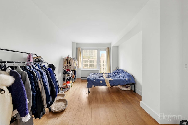 bedroom featuring hardwood / wood-style flooring and baseboards