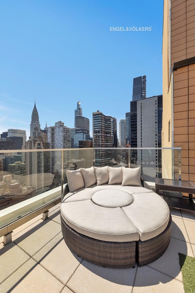 view of patio / terrace featuring a view of skyline and a balcony