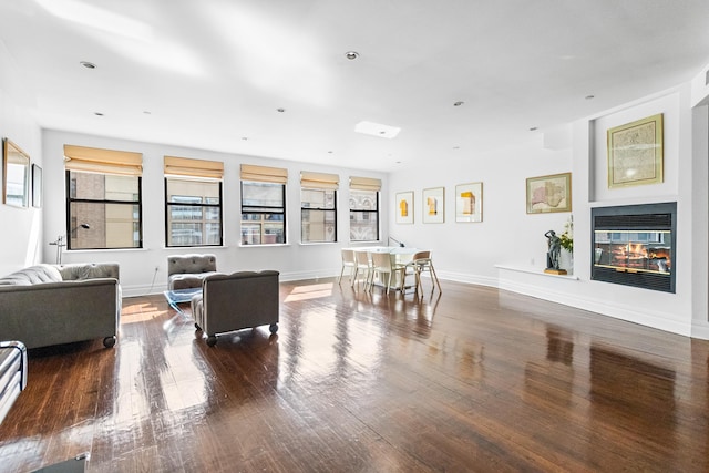 133 W 14th St Unit 6Ph, New York City, NY 10011 - living area with plenty of natural light, wood finished floors, a glass covered fireplace, and baseboards