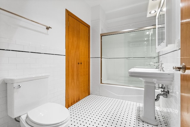 133 W 14th St Unit 6Ph, New York City, NY 10011 - full bath featuring tile walls, toilet, and bath / shower combo with glass door
