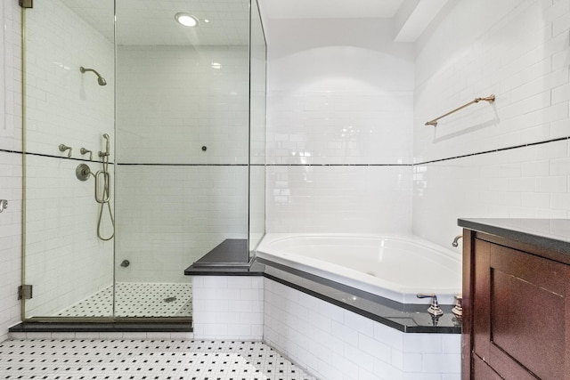 133 W 14th St Unit 6Ph, New York City, NY 10011 - full bathroom featuring a stall shower, a garden tub, tile walls, vanity, and recessed lighting