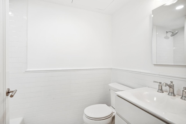 119 Henry St Unit 1, New York City, NY 11201 - bathroom featuring toilet, vanity, a shower, a wainscoted wall, and tile walls