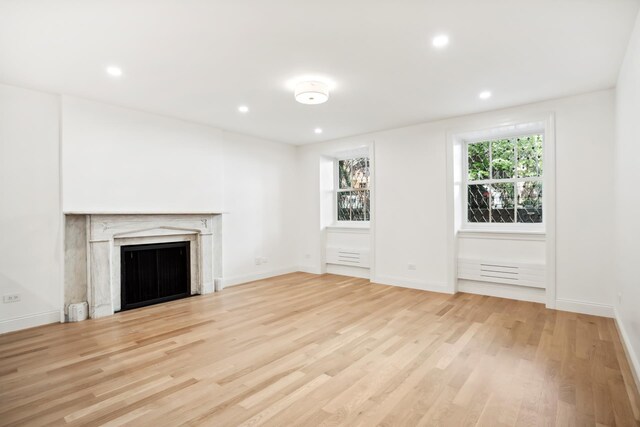119 Henry St Unit 1, New York City, NY 11201 - unfurnished living room featuring wood finished floors, recessed lighting, baseboards, and a fireplace