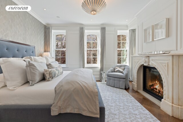 169 E 71st St, New York City, NY 10021 - bedroom with wallpapered walls, ornamental molding, and a premium fireplace