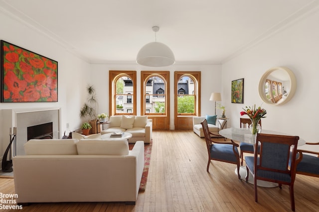 14 E 92nd St Unit 4, New York City, NY 10128 - living room featuring light wood-style floors, a fireplace, and crown molding