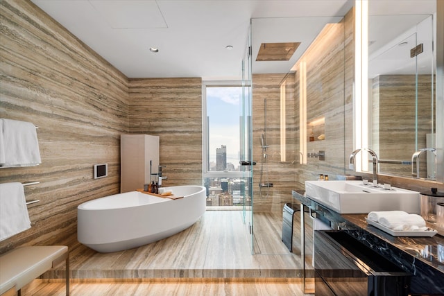 460 W 42nd St Unit Ph-1C, New York City, NY 10036 - full bath featuring a stall shower, a freestanding tub, vanity, and expansive windows