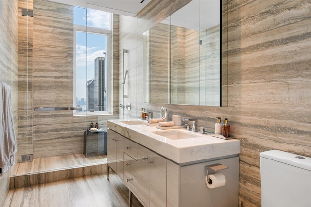 460 W 42nd St Unit Ph-1C, New York City, NY 10036 - full bathroom with toilet, plenty of natural light, double vanity, and tile walls