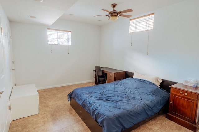 bedroom featuring multiple windows, a ceiling fan, and light colored carpet