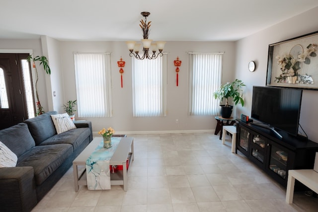living area with a chandelier and baseboards