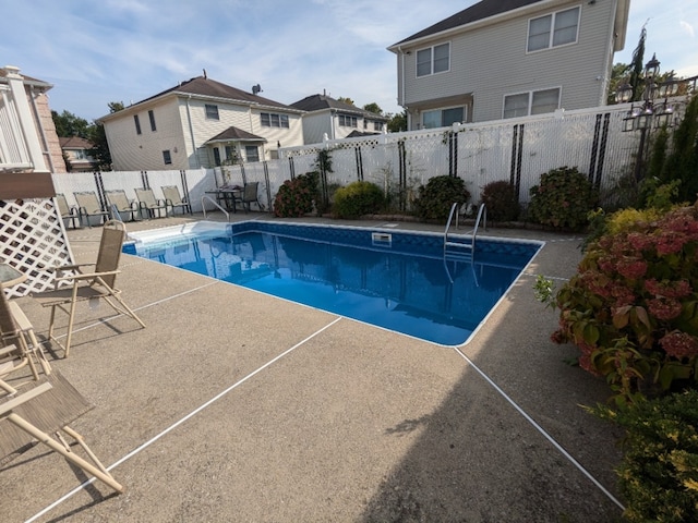view of pool featuring a fenced backyard and a patio