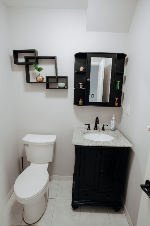 bathroom with baseboards, vanity, and toilet