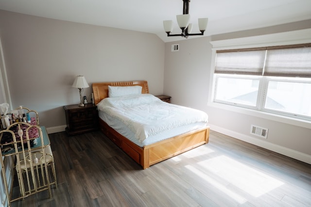 bedroom with baseboards, wood finished floors, a chandelier, a ceiling fan, and lofted ceiling