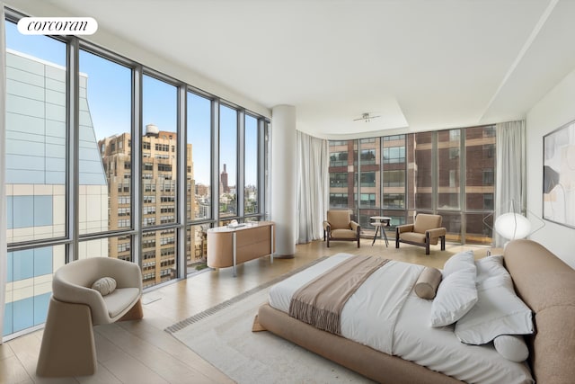565 Broome St Unit S16B, New York City, NY 10013 - bedroom with a wall of windows, a city view, and wood finished floors