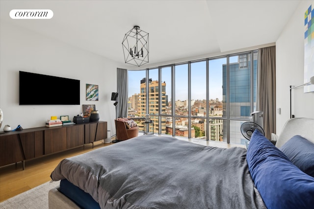 565 Broome St Unit S16B, New York City, NY 10013 - bedroom with wood finished floors, floor to ceiling windows, and a chandelier