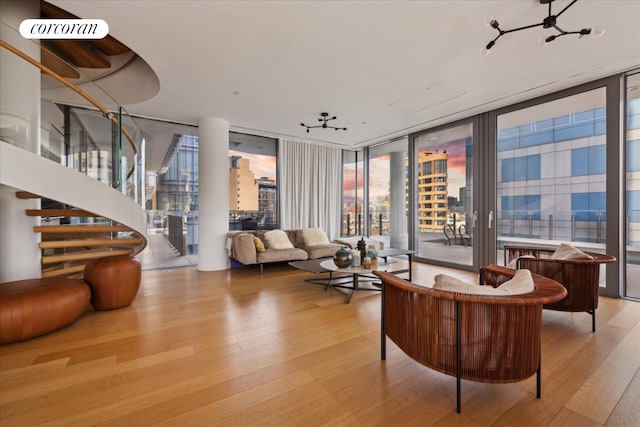 565 Broome St Unit S16B, New York City, NY 10013 - living area with a wall of windows, wood finished floors, and stairs