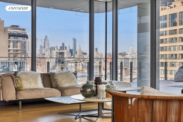 565 Broome St Unit S16B, New York City, NY 10013 - living area featuring a skyline view, plenty of natural light, expansive windows, and wood finished floors