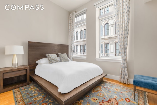 bedroom with wood finished floors and baseboards