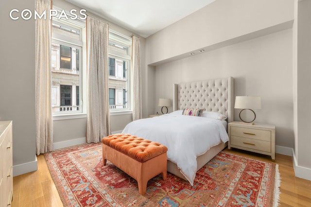 bedroom featuring light wood-style floors and baseboards