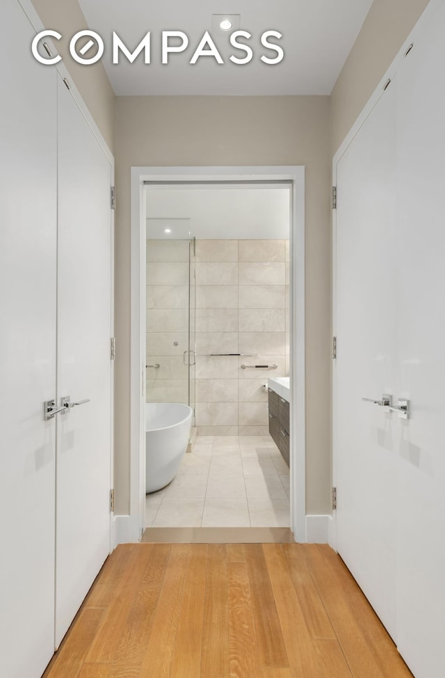 101 Leonard St Unit 2E, New York City, NY 10013 - bathroom featuring a freestanding bath, vanity, tile patterned floors, a shower, and baseboards