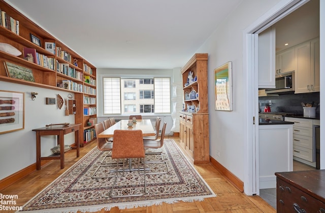 179 E 70th St Unit 11A, New York City, NY 10021 - dining area featuring baseboards