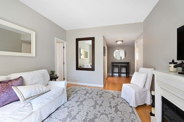188 E 70th St Unit 16B, New York City, NY 10021 - living room featuring light wood-style flooring and a fireplace