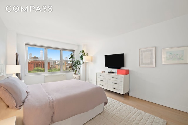 bedroom featuring light wood-style flooring and baseboards