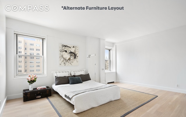 bedroom featuring light wood-style flooring and baseboards