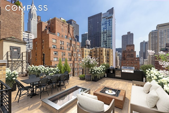 105 E 38th St Unit Ph10, New York City, NY 10016 - view of patio featuring area for grilling, a view of skyline, and an outdoor living space with a fire pit
