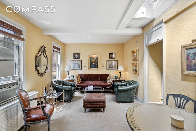 living room with carpet, beam ceiling, and a textured wall