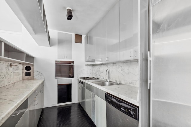 300 E 33rd St Unit 9M, New York City, NY 10016 - kitchen featuring appliances with stainless steel finishes, a sink, decorative backsplash, and light countertops