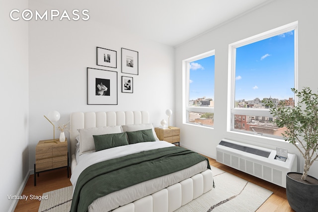 139 Skillman Ave Unit 7B, New York City, NY 11211 - bedroom featuring wood finished floors and radiator heating unit