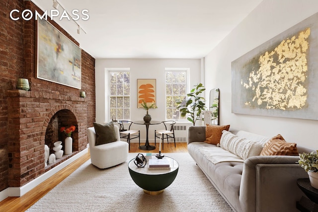 333 W 21st St Unit 2Fe, New York City, NY 10011 - living room featuring wood finished floors and a fireplace