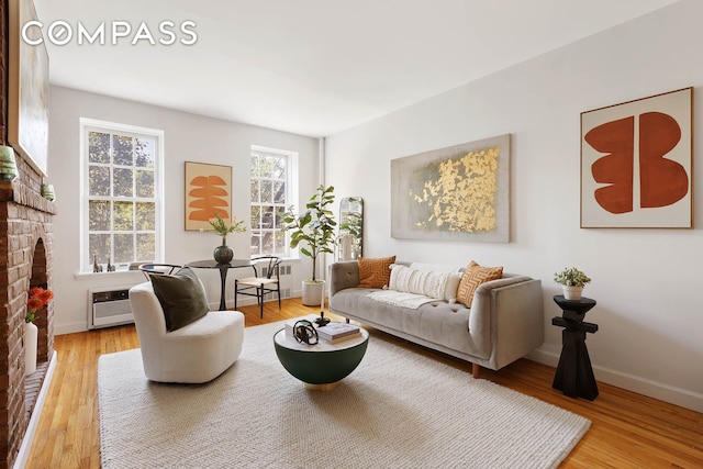 333 W 21st St Unit 2Fe, New York City, NY 10011 - living room with a fireplace, wood finished floors, and baseboards