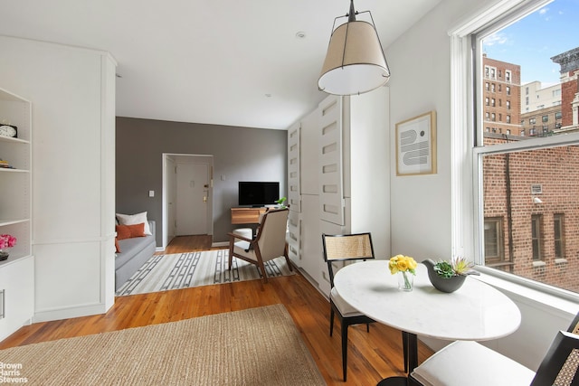 dining area featuring wood finished floors and baseboards
