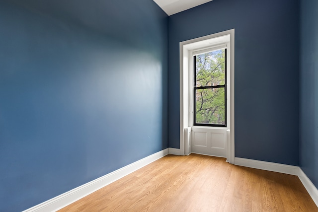 spare room with light wood-style floors and baseboards
