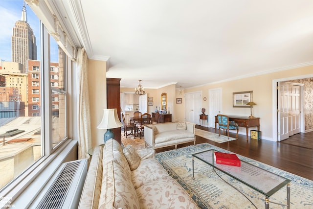 137 E 36th St Unit 7K, New York City, NY 10016 - living room featuring ornamental molding, a chandelier, wood finished floors, and a view of city