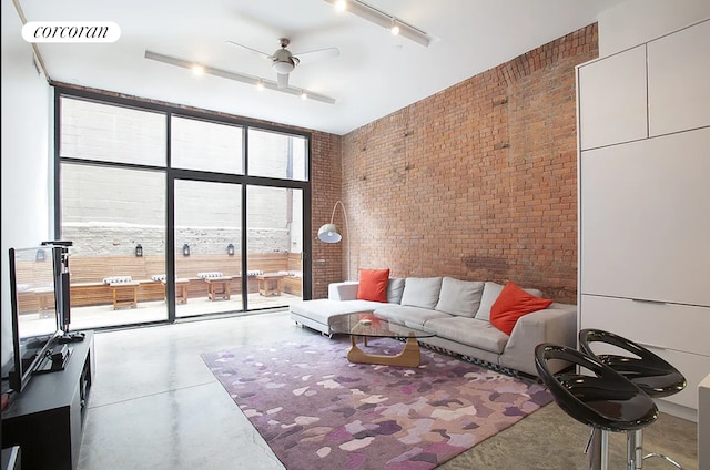 192 Water St Unit 1W, New York City, NY 11201 - living room featuring expansive windows, brick wall, concrete flooring, ceiling fan, and track lighting
