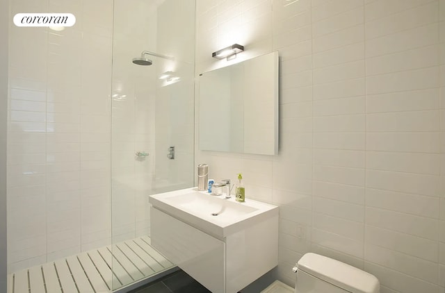 192 Water St Unit 1W, New York City, NY 11201 - bathroom with a walk in shower, toilet, vanity, and tile walls