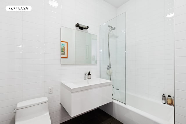 192 Water St Unit 1W, New York City, NY 11201 - bathroom with toilet, vanity, tile walls, and tub / shower combination