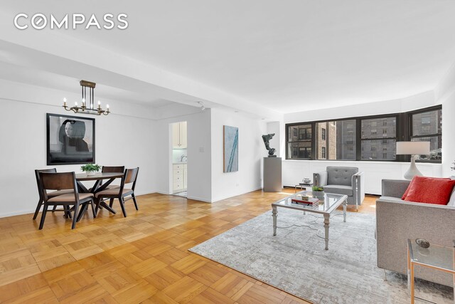 120 E 81st St Unit 8A, New York City, NY 10028 - living room featuring a chandelier and baseboards