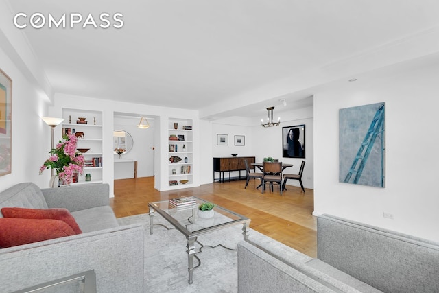 120 E 81st St Unit 8A, New York City, NY 10028 - living area featuring a chandelier and built in shelves