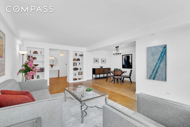 120 E 81st St Unit 8A, New York City, NY 10028 - living area with a chandelier and built in shelves