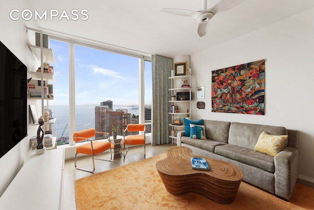 50 W St Unit 37C, New York City, NY 10006 - living area with wood finished floors, a ceiling fan, a water view, and a wall of windows